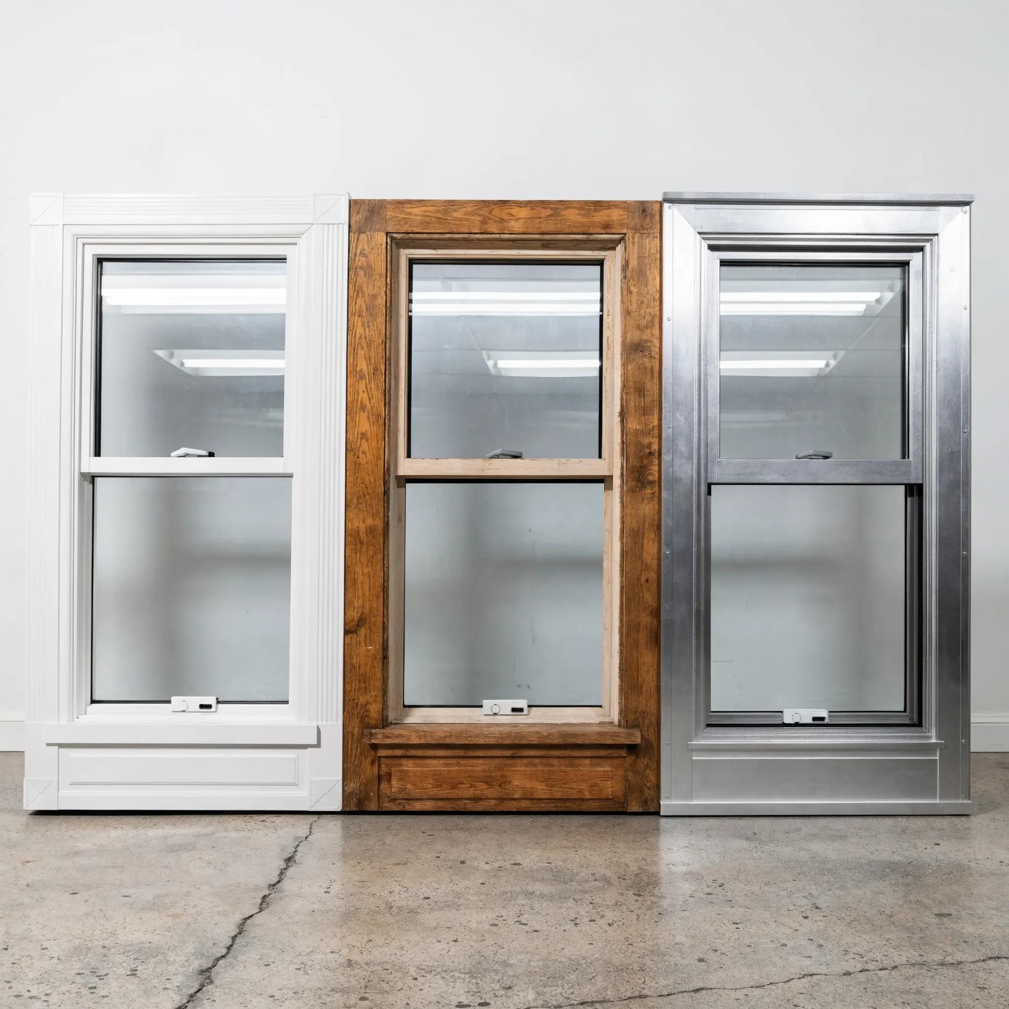 Comparison of vinyl, wood, and aluminum window frames showcasing their unique textures and finishes
